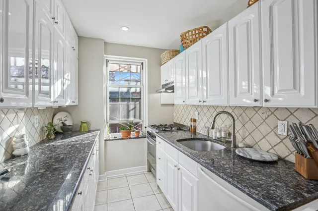 a kitchen with a sink stove and cabinets