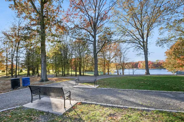 a swimming pool with outdoor seating and trees