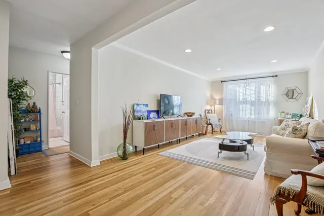 a bedroom with furniture and a wooden floor