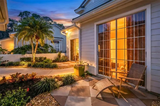 a outdoor living room with furniture and a large window
