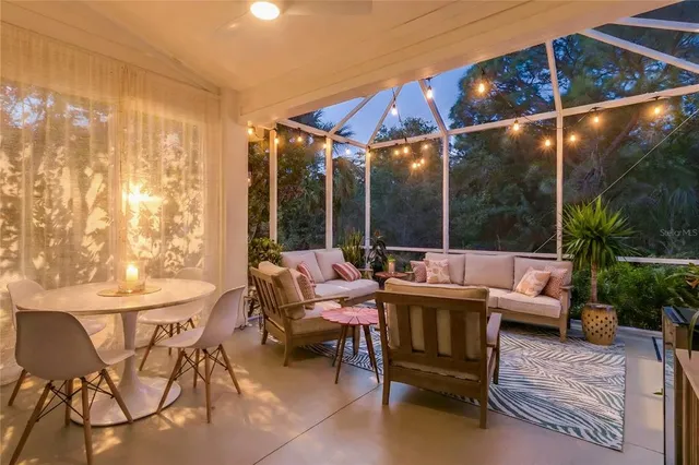 an aerial view of a house with large trees and plants