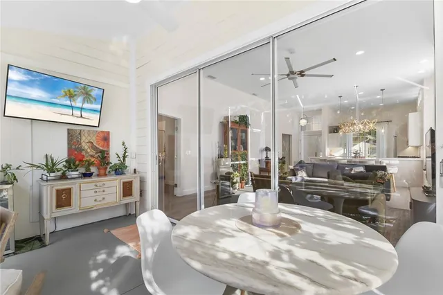 a front view of a house with a garden and trees