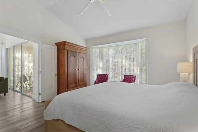 a room with lots of tables a large window and chairs