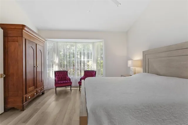 a dining room with furniture window and wooden floor