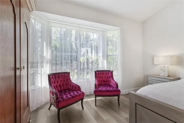 a view of a dining room with furniture large windows and garden view