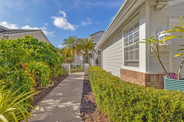 a kitchen with stainless steel appliances granite countertop a stove a sink dishwasher and a dining table with wooden cabinet