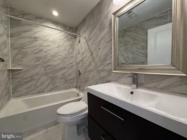 a bathroom with a sink a toilet and a bathtub