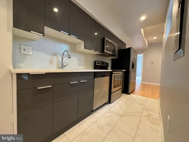 a kitchen with stainless steel appliances granite countertop a sink and cabinets