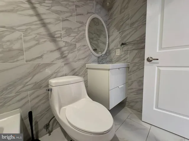a white toilet sitting next to a shower