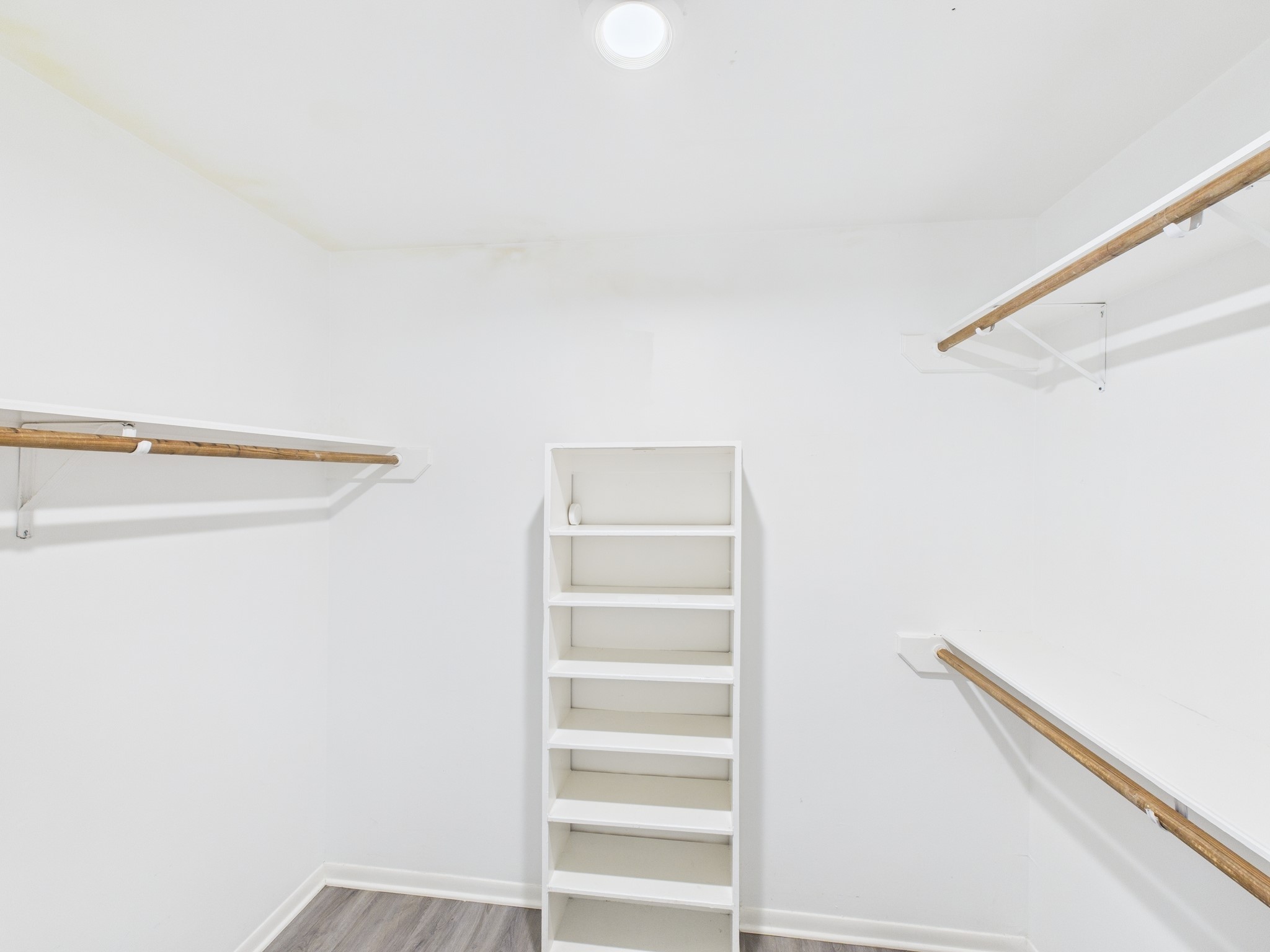 7611 Hopewell Lane Houston, TX 77071 - Photo 27 of 30 a view of walk in closet with empty racks