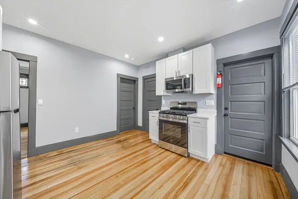 a kitchen with granite countertop a stove and a refrigerator