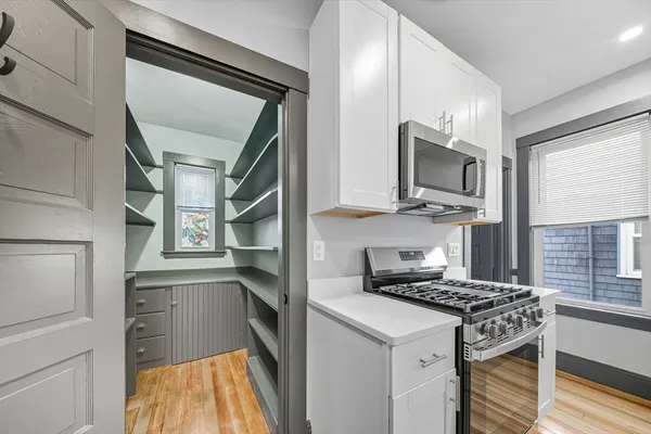 a kitchen with stainless steel appliances granite countertop a stove microwave and cabinets