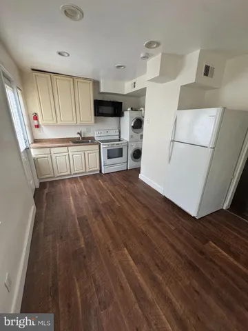 a kitchen with stainless steel appliances a stove a sink and a refrigerator