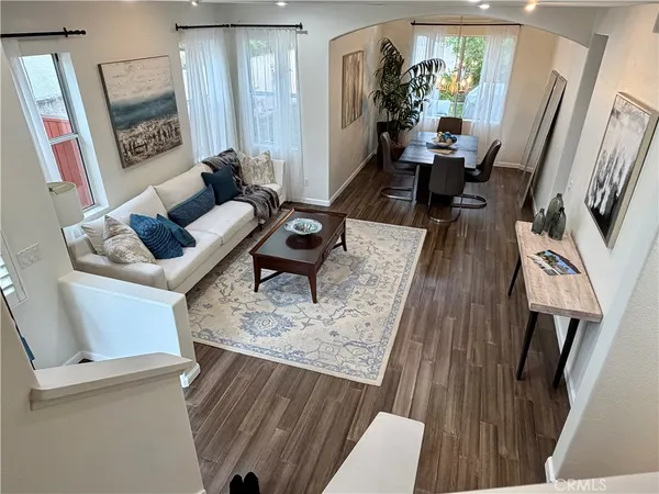 a living room with wooden floor and a flat screen tv