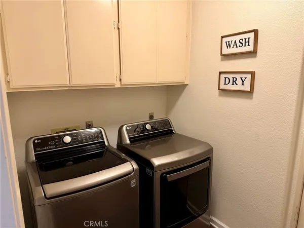 a living room with furniture a rug and a wall painting