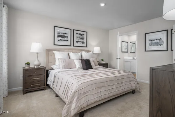 a living room with furniture a flat screen tv and kitchen view
