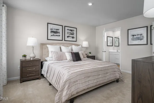 a living room with furniture a flat screen tv and kitchen view