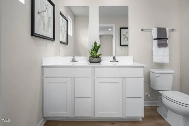a bathroom with a toilet a sink and glass door