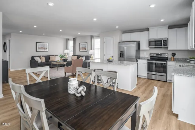 a kitchen with white cabinets and sink