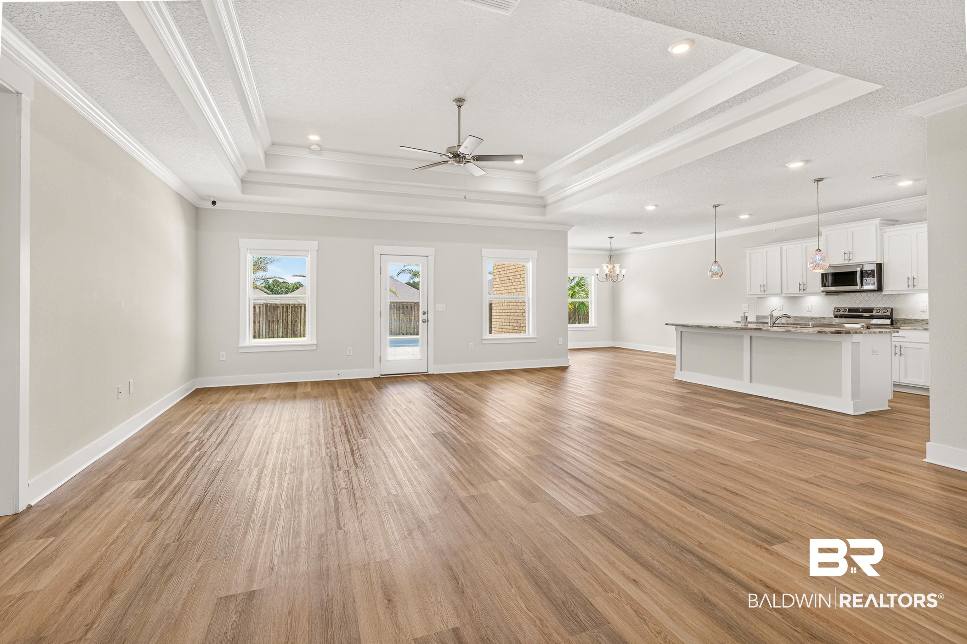 1724 Partridge Street Foley, AL 36535 - Photo 14 of 62 Spacious open-concept living area featuring wood-finish flooring, a coffered ceiling with recessed lighting, and a ceiling fan