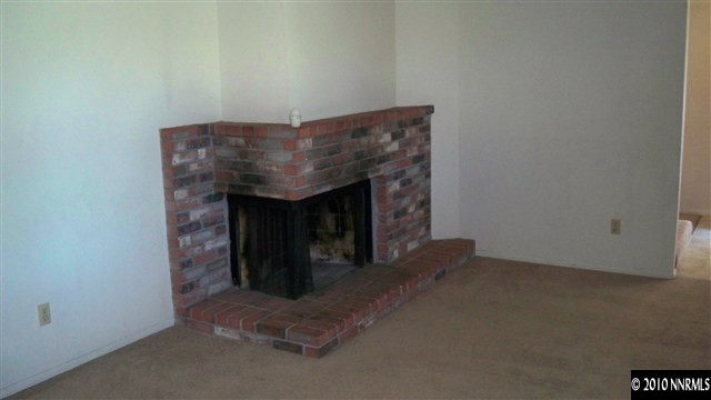 7480 Berryhill Drive Reno, NV 89511 - Photo 3 of 9 a view of an empty room with a fireplace