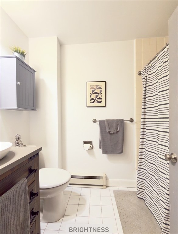 9 Albemarle Street, Unit 2 Boston, MA 02115 - Photo 7 of 11 a bathroom with a sink a toilet and mirror
