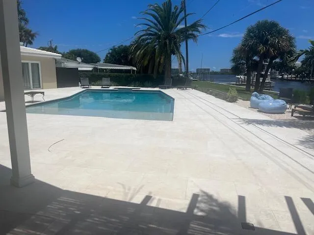 a view of a backyard with swimming pool