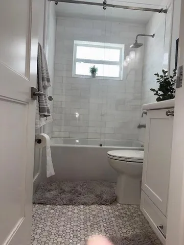 a bathroom with a toilet sink and shower