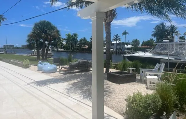 a view of a lake with a bench in patio