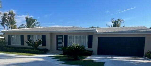 a dining room with furniture and a floor to ceiling window