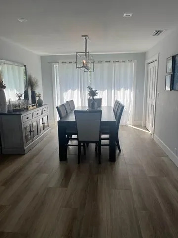 a kitchen with lots of counter top space and dining table