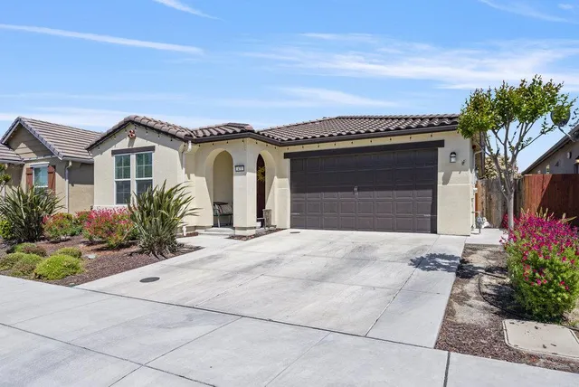 front view of a house with a bench and a pathway