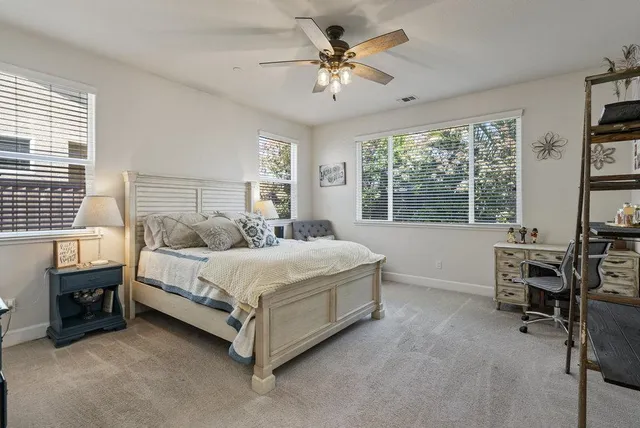 a bathroom with a sink a toilet a mirror and shower