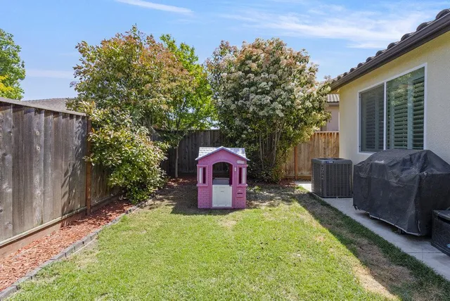 a view of an house with backyard space and garden