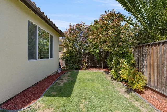 a front view of a house with a yard and seating space