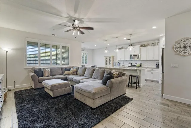 a living room with furniture fireplace and a flat screen tv