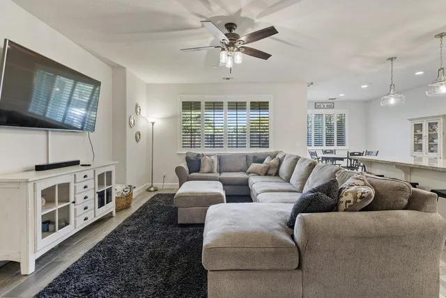 a kitchen with kitchen island granite countertop a center island a sink stainless steel appliances and cabinets
