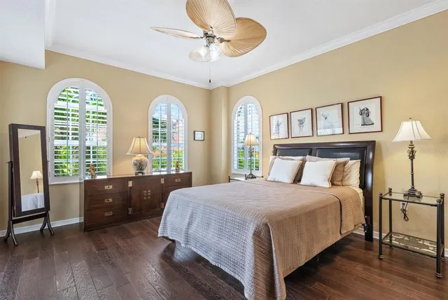 a bedroom with a large bed and a chandelier
