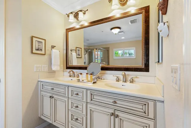 a bathroom with a tub a window and glass door shower
