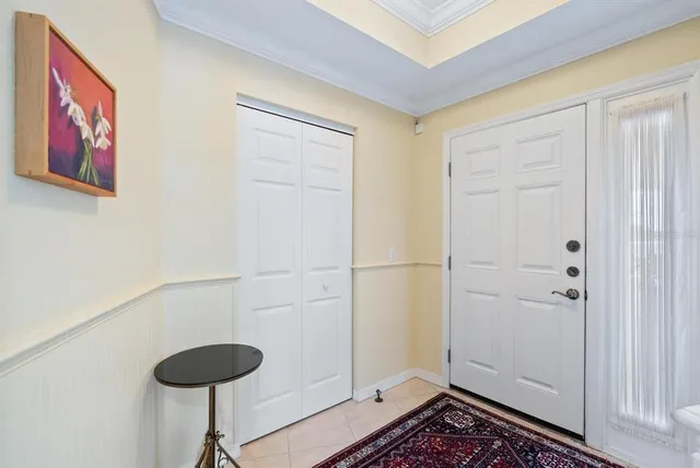 a view of a hallway with wooden floor and chandelier