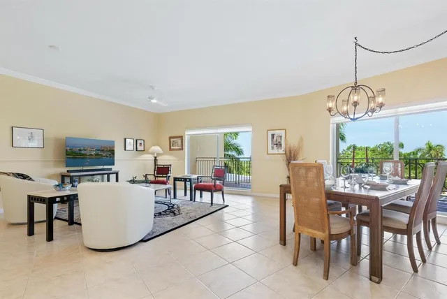 a dining room with furniture and a chandelier