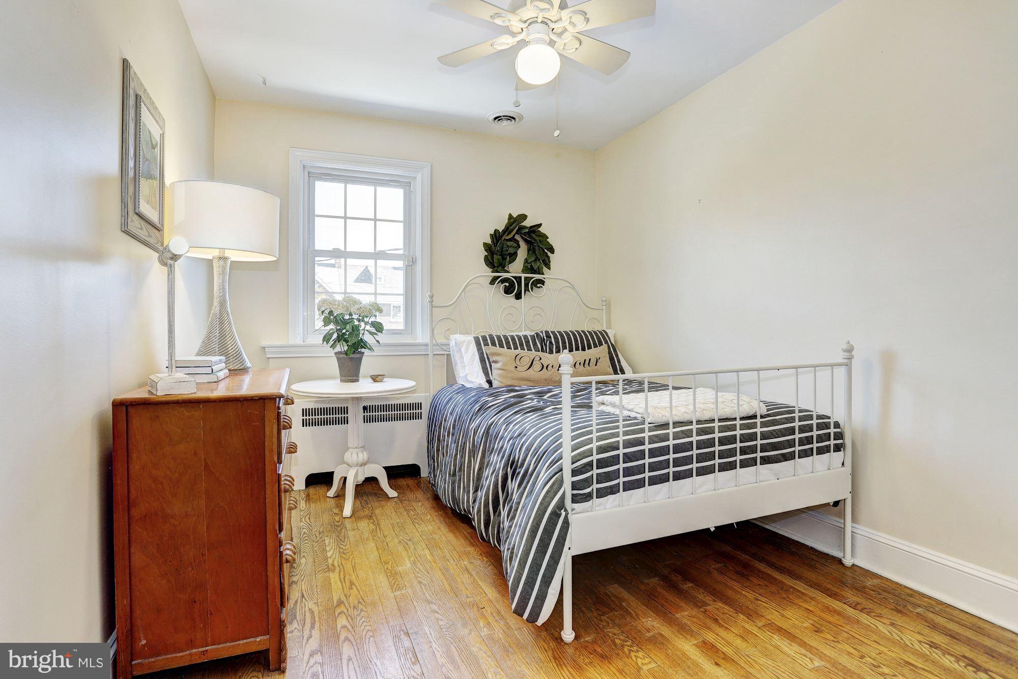 408 Dunkirk Road Baltimore, MD 21212 - Photo 12 of 22 a bedroom with a bed and wooden floor