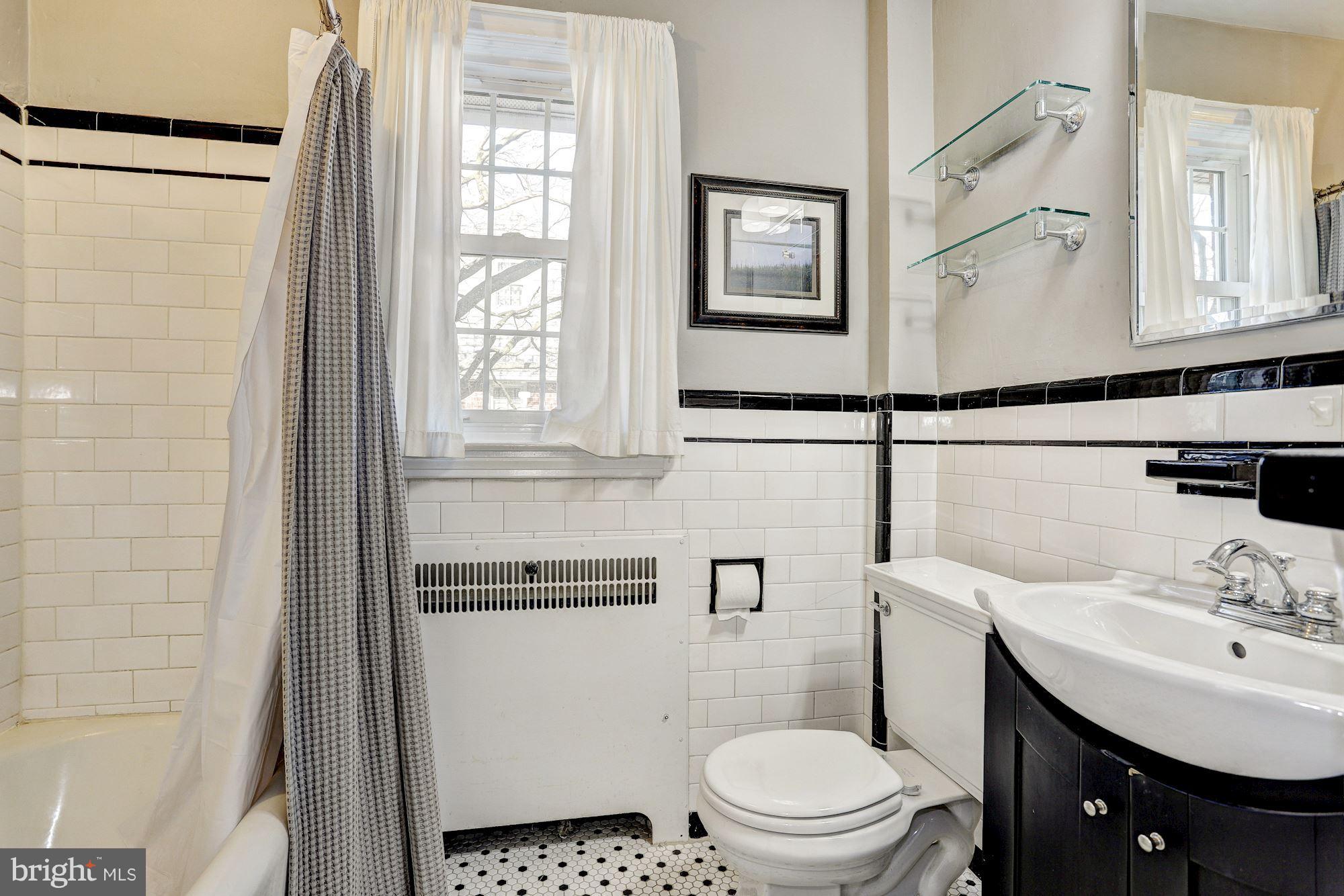 408 Dunkirk Road Baltimore, MD 21212 - Photo 14 of 22 a bathroom with a sink toilet and shower