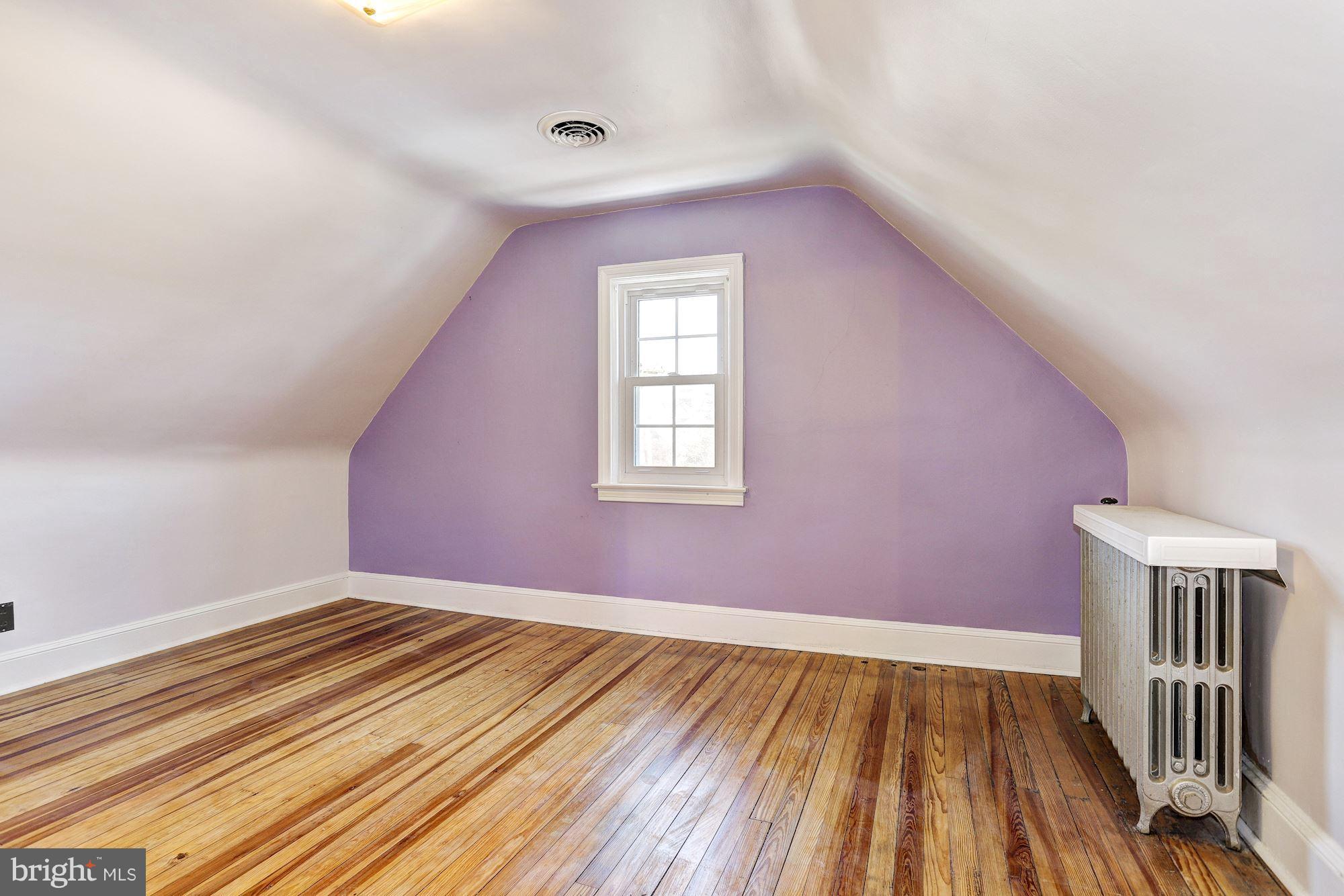 408 Dunkirk Road Baltimore, MD 21212 - Photo 15 of 22 a view of an empty room with wooden floor and a window