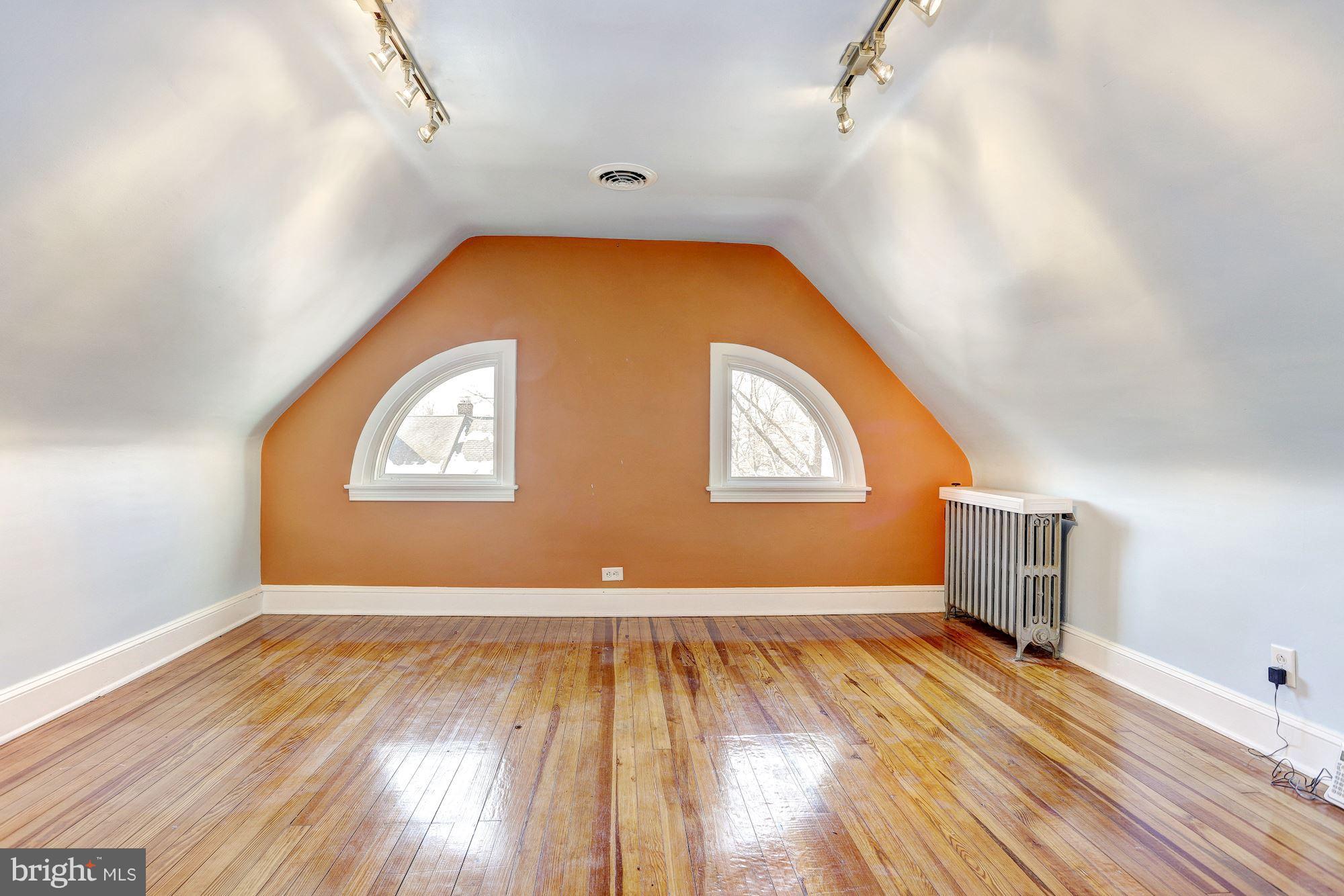 408 Dunkirk Road Baltimore, MD 21212 - Photo 16 of 22 an empty room with wooden floor and windows