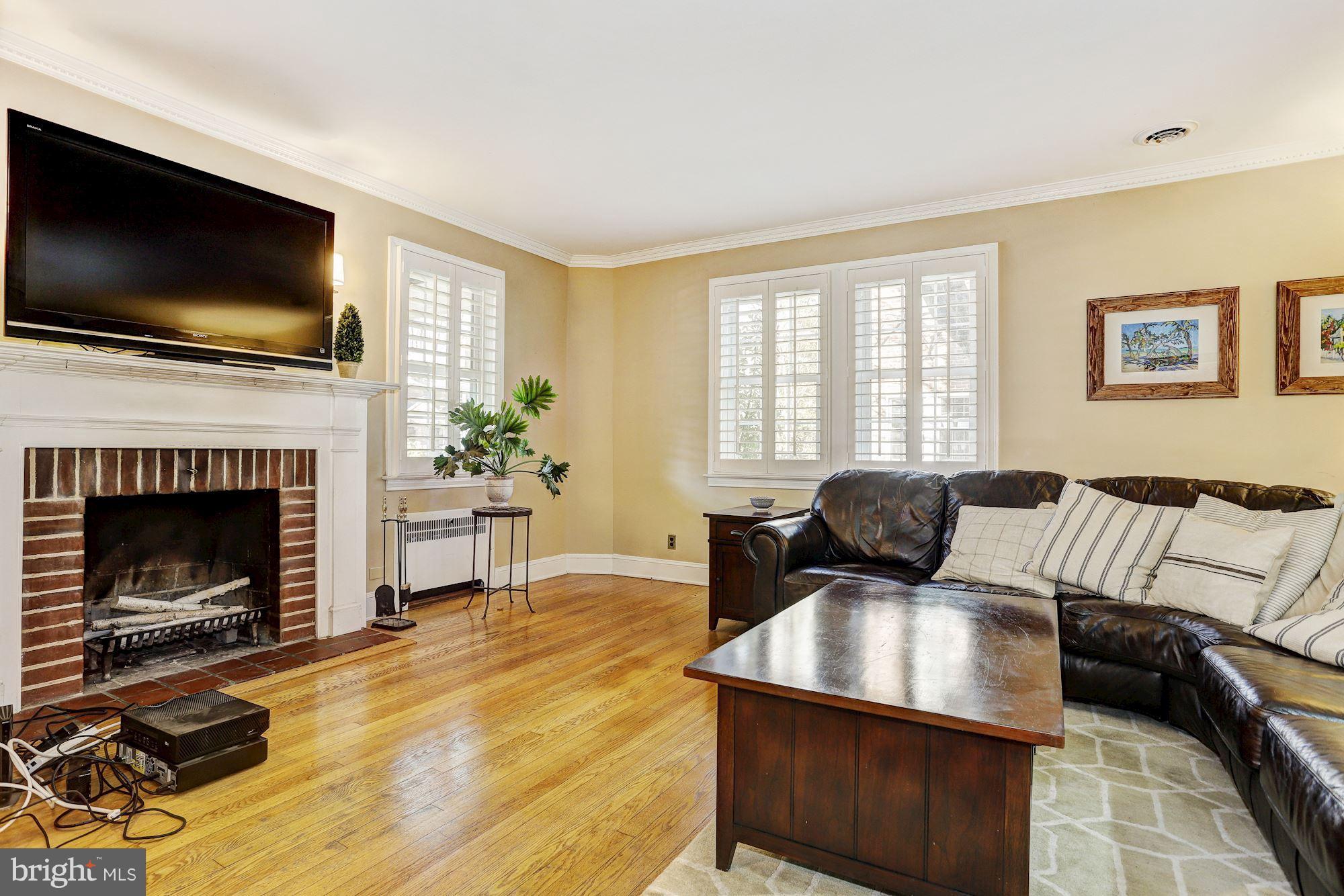 408 Dunkirk Road Baltimore, MD 21212 - Photo 4 of 22 a living room with furniture a flat screen tv and a fireplace