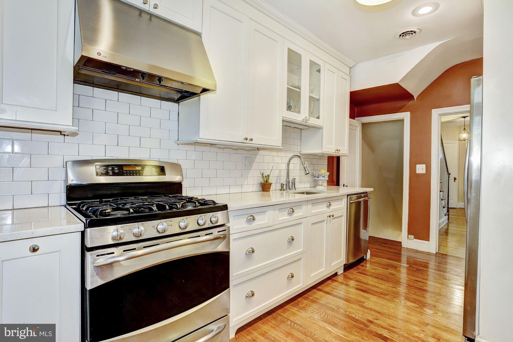 408 Dunkirk Road Baltimore, MD 21212 - Photo 10 of 22 a kitchen with stainless steel appliances a stove a refrigerator and a cabinets