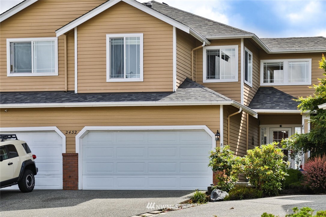 2432 195th Place Southeast, Unit B Bothell, WA 98012 - Photo 1 of 34 a front view of a house with garage
