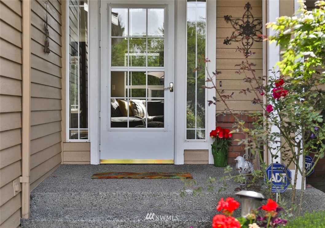 2432 195th Place Southeast, Unit B Bothell, WA 98012 - Photo 2 of 34 a front view of a house with a yard