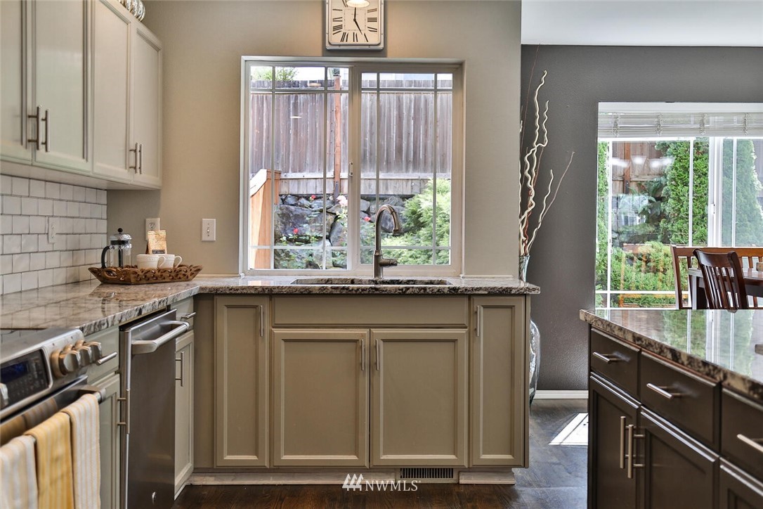 2432 195th Place Southeast, Unit B Bothell, WA 98012 - Photo 11 of 34 a kitchen with stainless steel appliances granite countertop a stove and a sink